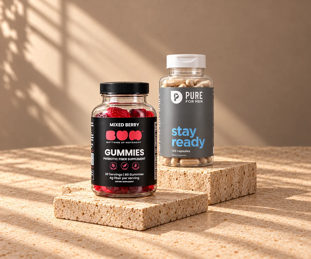 BUM fiber gummies and Pure For Men Stay Ready supplements arranged on sunlit stone